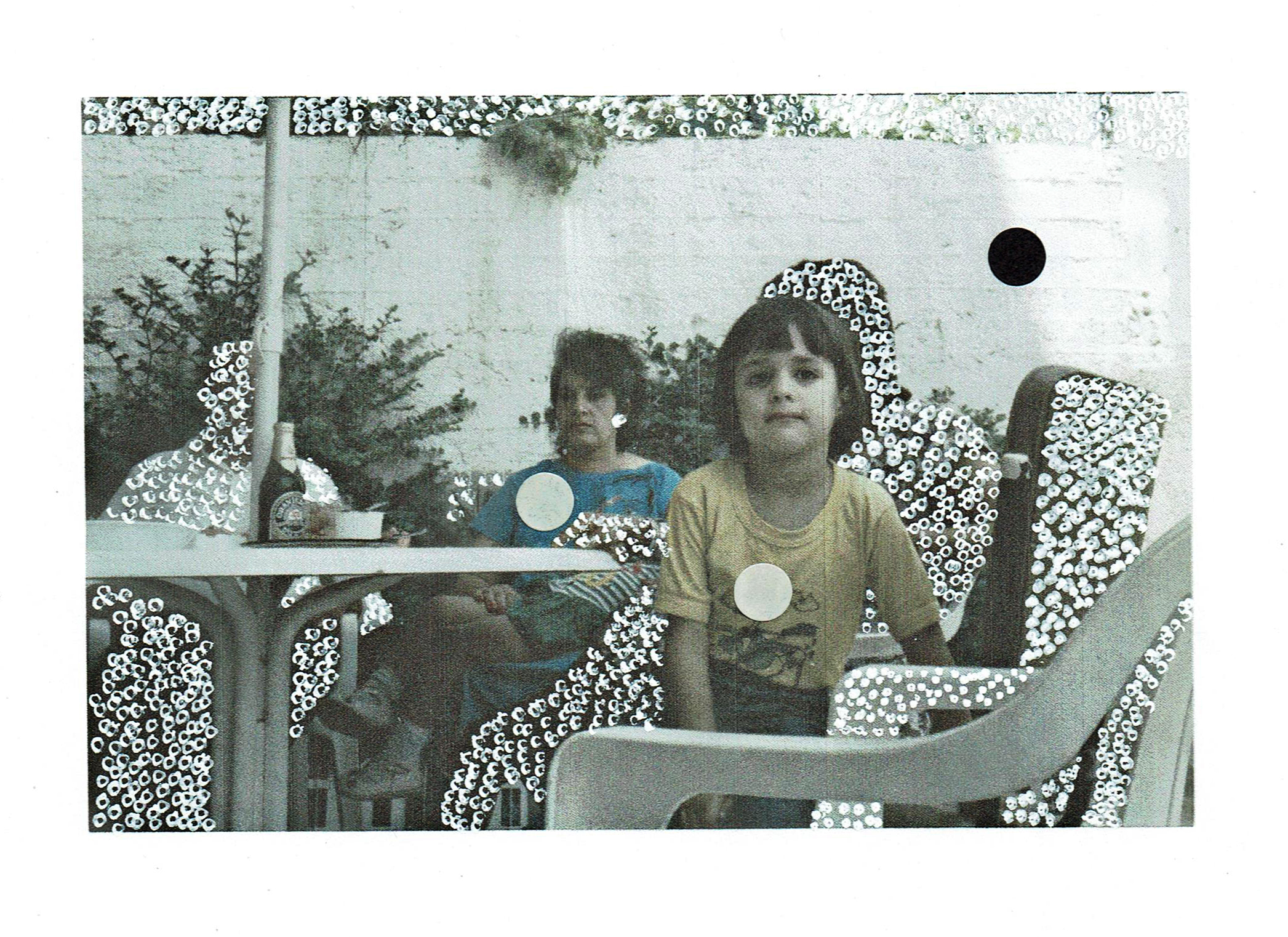 a photograph of a mother and child decorated with white and black dots. 